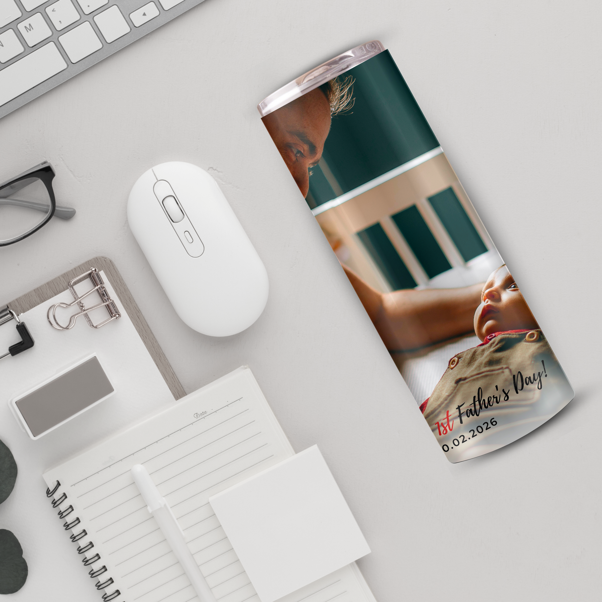 a variety of office supplies and a computer mouse, including a notebook, a pen, a computer mouse, and a pair of glasses.