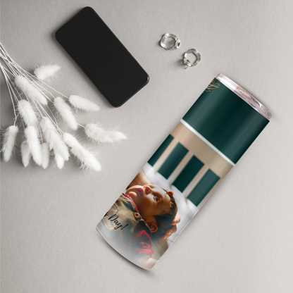 a cylindrical object with a printed image of a person's face on it, along with a black phone and earrings.
