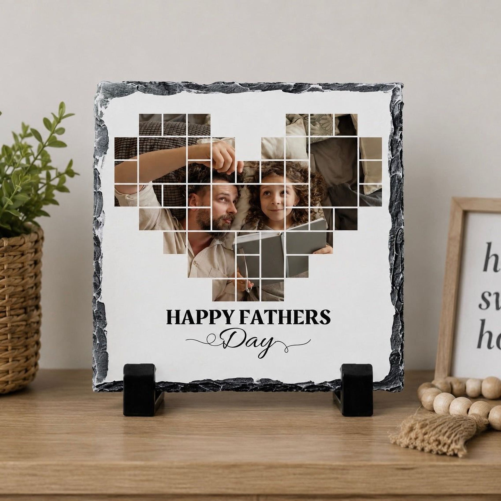 A heart-shaped photo frame on a wooden surface, displaying a collage of images of a man and a woman, with the text "Happy Fathers Day" written on the frame.
