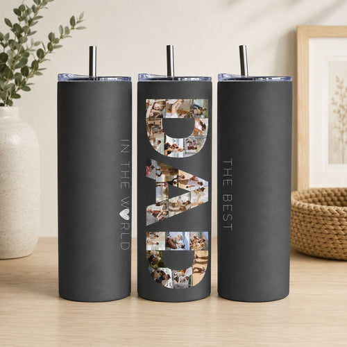 A black tumblers with the word "DAD" printed on them, along with a straw.