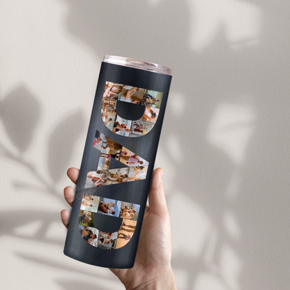 A person's hand holding a black tumbler with the word "DAD" printed on it in large letters.