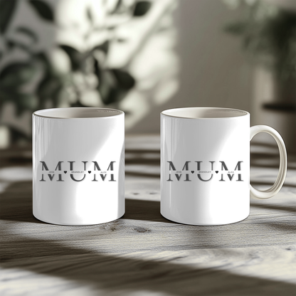 White mugs with the word "MUM" printed on them, placed on a wooden surface.